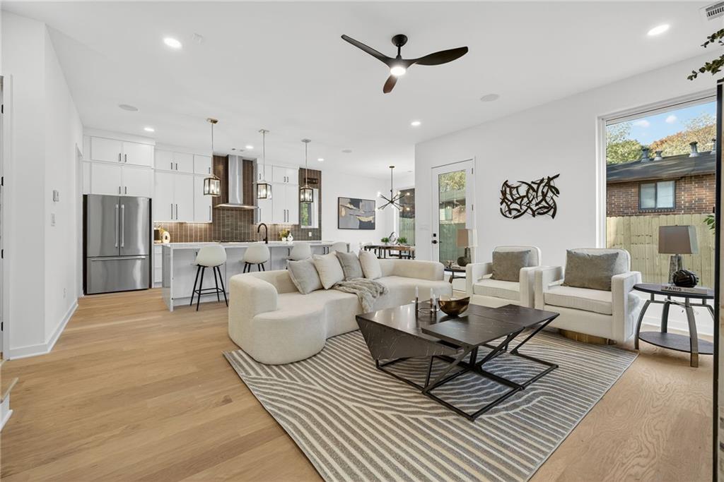 163 Walthall Street Southeast, Unit B Atlanta, GA 30316 - Photo 3 of 37 a living room with furniture a rug and a chandelier