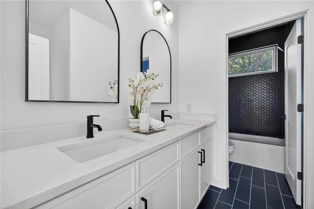163 Walthall Street Southeast, Unit B Atlanta, GA 30316 - Photo 31 of 37 a bathroom with a sink and a mirror
