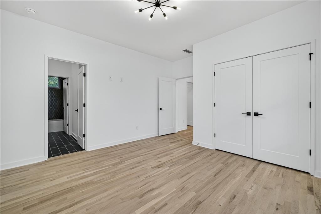 163 Walthall Street Southeast, Unit B Atlanta, GA 30316 - Photo 32 of 37 a view of a room with wooden floor and a ceiling fan