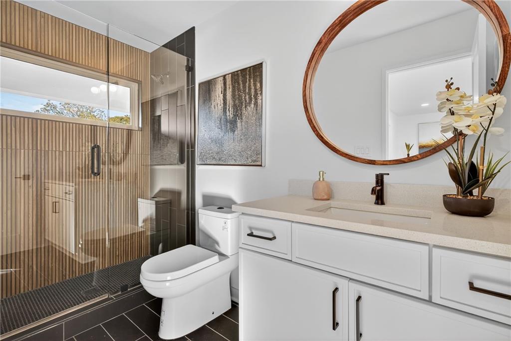 163 Walthall Street Southeast, Unit B Atlanta, GA 30316 - Photo 33 of 37 a bathroom with a sink a toilet and a mirror