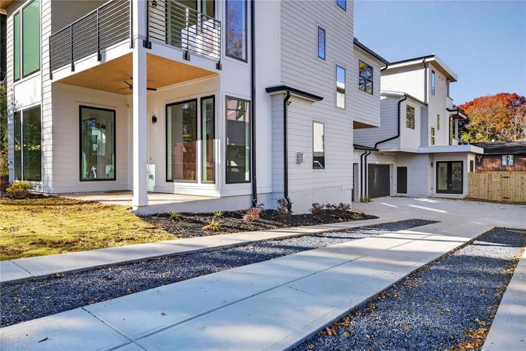 163 Walthall Street Southeast, Unit B Atlanta, GA 30316 - Photo 35 of 37 a view of a white house with large windows next to a road