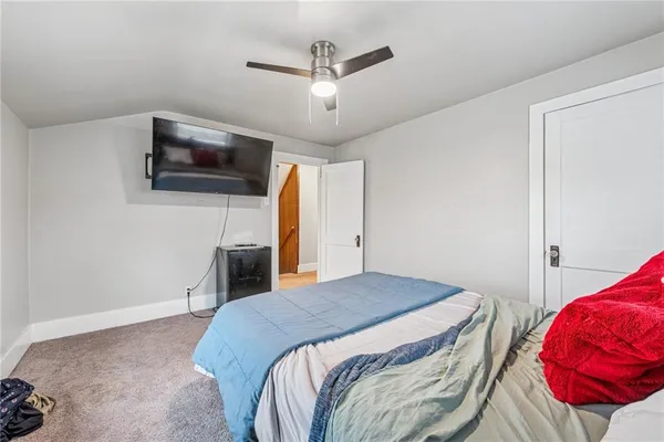 a bedroom with a bed and a television