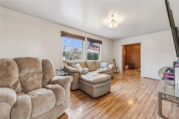 a living room with furniture a couch and a window