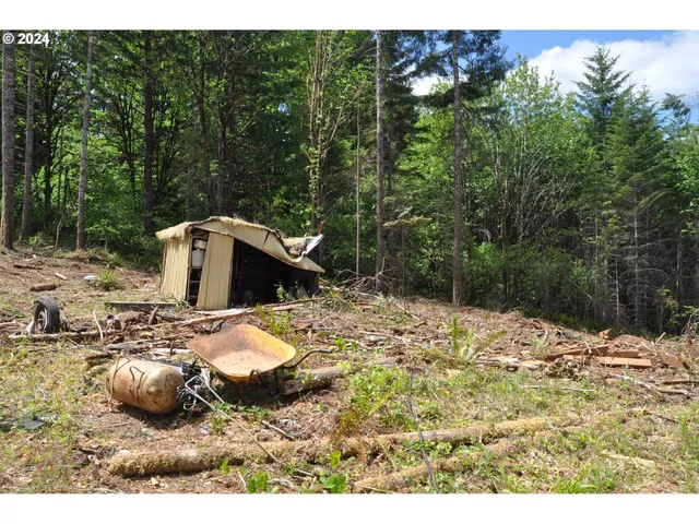 a view of a backyard with table and chairs and wooden fence