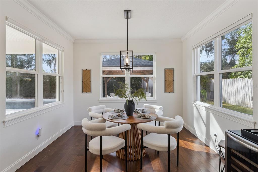 5018 Monet Avenue Belle Isle, FL 32812 - Photo 14 of 56 a dining room with furniture a chandelier and wooden floor