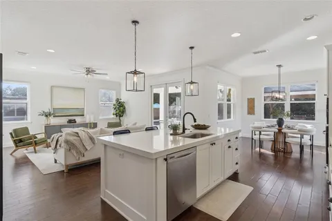 a kitchen with stainless steel appliances kitchen island granite countertop a sink and cabinets