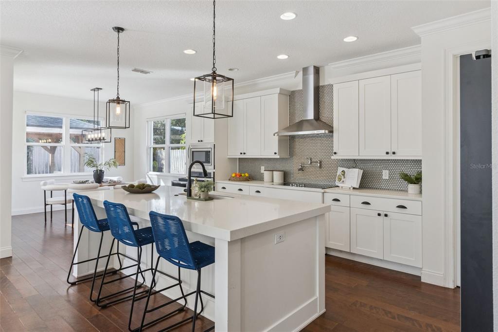 5018 Monet Avenue Belle Isle, FL 32812 - Photo 16 of 56 a kitchen with stainless steel appliances kitchen island granite countertop a sink and cabinets