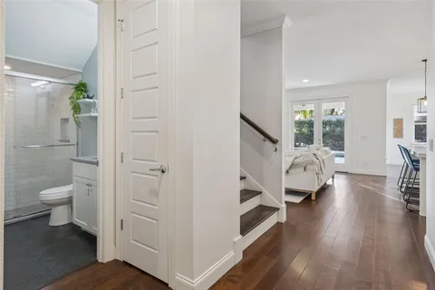 a view of staircase with railing and white walls