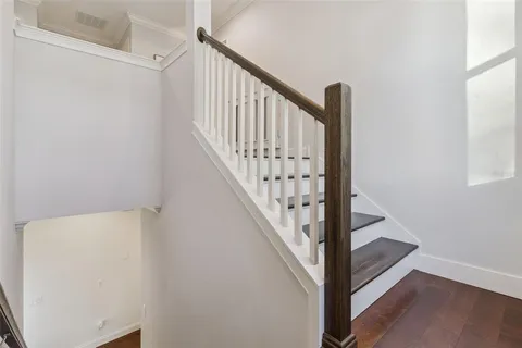 a bedroom with wooden floors and a bed