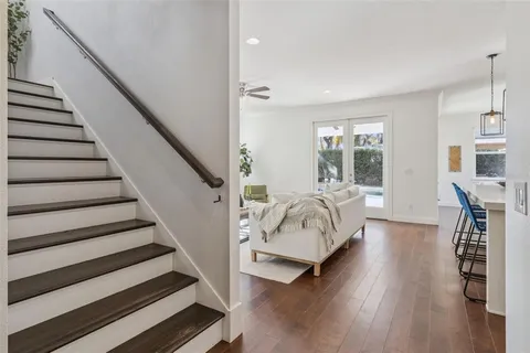 a bathroom with a tub shower hardwood and a sink