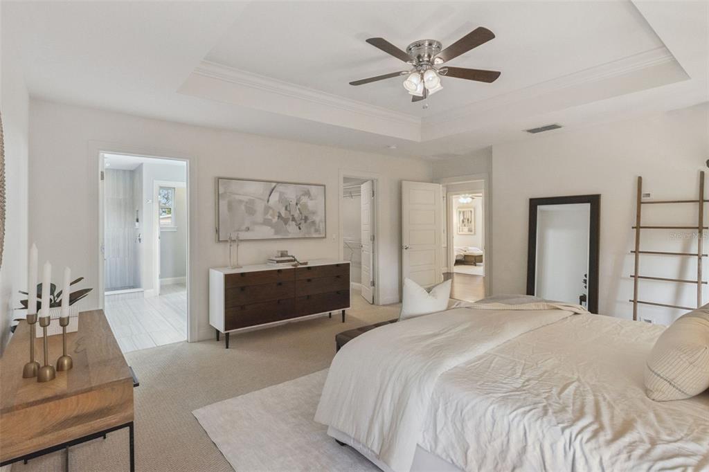 5018 Monet Avenue Belle Isle, FL 32812 - Photo 28 of 56 a bedroom with a bed and a chandelier