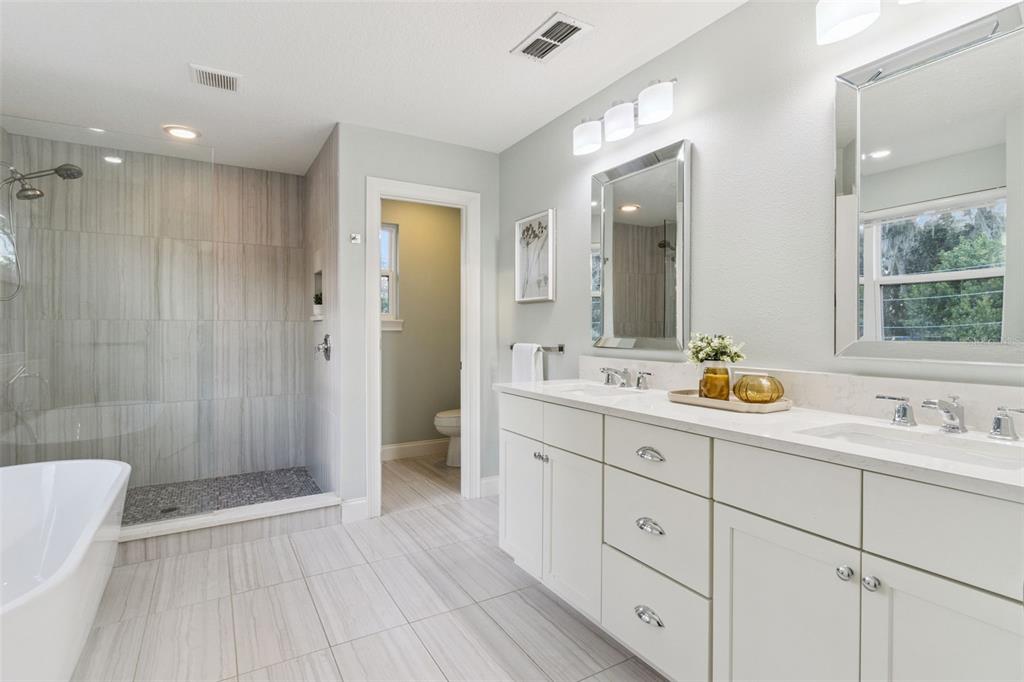 5018 Monet Avenue Belle Isle, FL 32812 - Photo 29 of 56 a bathroom with a double vanity sink toilet and shower