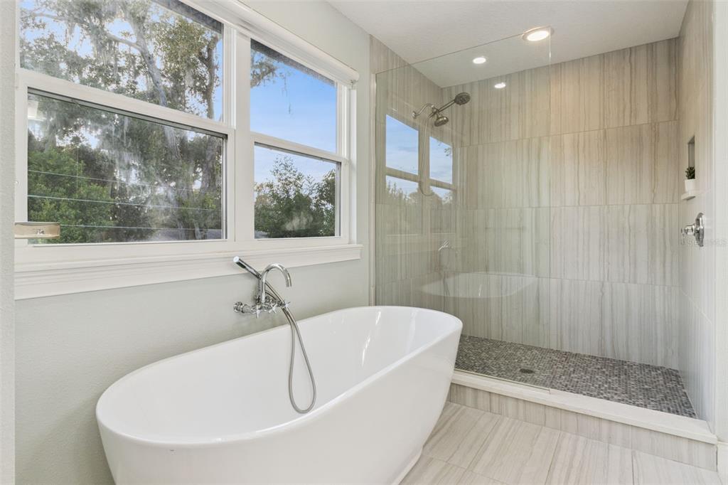 5018 Monet Avenue Belle Isle, FL 32812 - Photo 31 of 56 a white bath tub sitting next to a shower