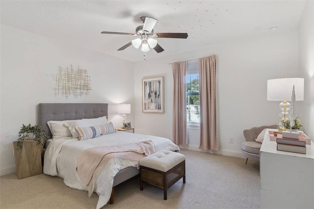 5018 Monet Avenue Belle Isle, FL 32812 - Photo 32 of 56 a spacious bedroom with a bed and a chandelier
