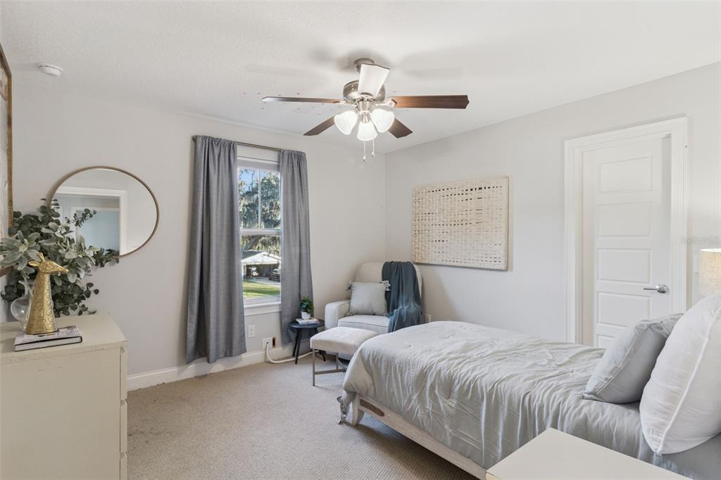 5018 Monet Avenue Belle Isle, FL 32812 - Photo 34 of 56 a bedroom with a large bed and a chandelier