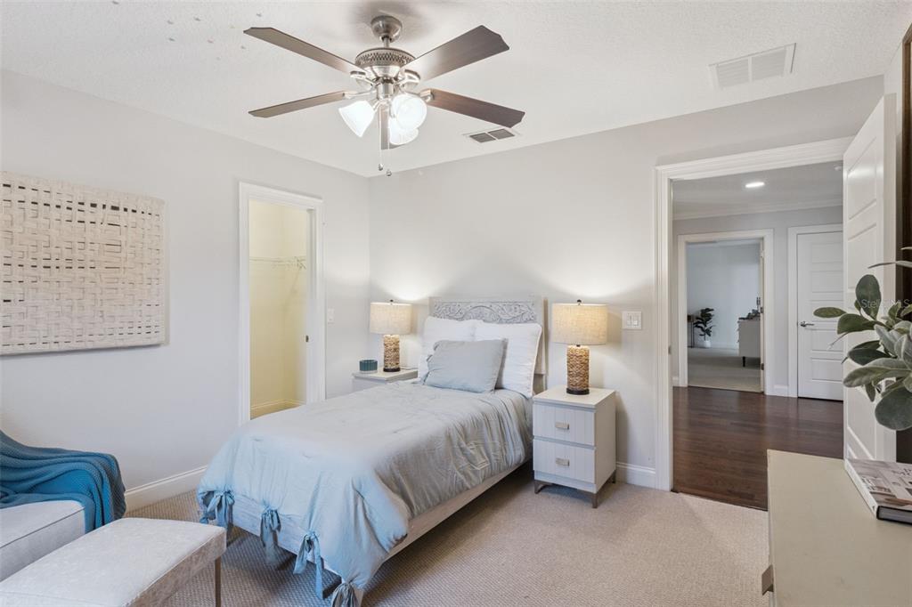 5018 Monet Avenue Belle Isle, FL 32812 - Photo 35 of 56 a bedroom with a bed a couch and a chandelier