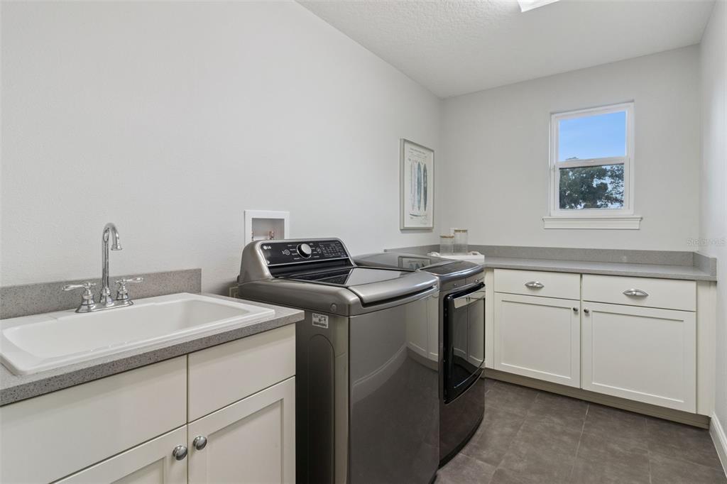 5018 Monet Avenue Belle Isle, FL 32812 - Photo 37 of 56 a utility room with sink dryer and washer