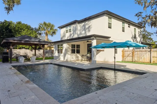 swimming pool view with a seating space