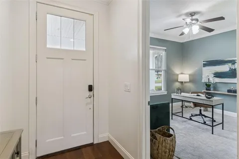 a view of a workspace with furniture and a bathroom