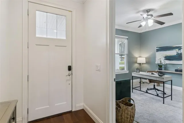 a view of a workspace with furniture and a bathroom