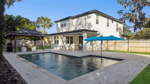 a view of residential houses with outdoor space and street view