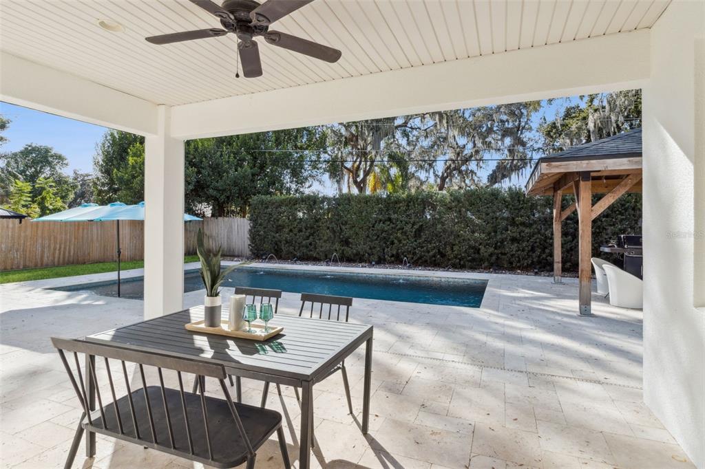 5018 Monet Avenue Belle Isle, FL 32812 - Photo 43 of 56 a view of a patio with a table chairs and a floor to ceiling window