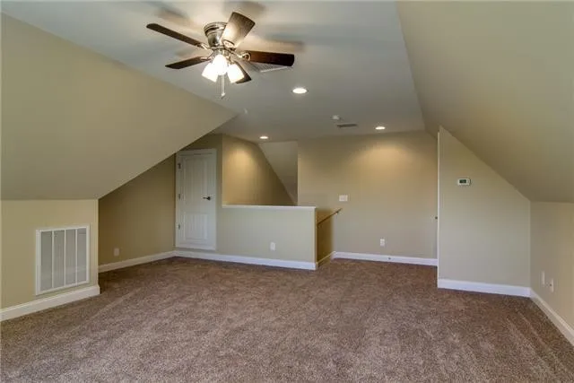 a view of an empty room with a ceiling fan