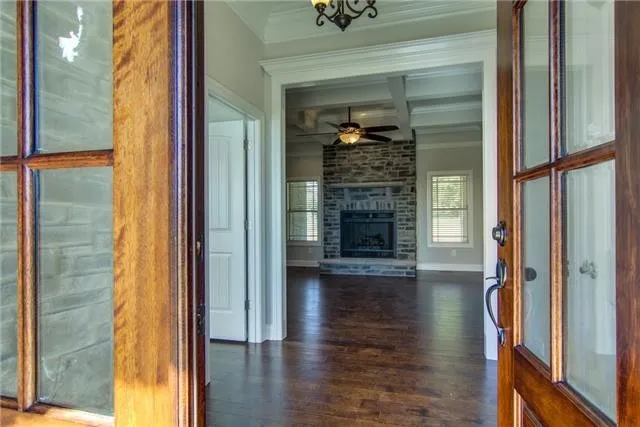 a view of empty room with wooden floor and fireplace