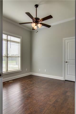 427 Favre Circle Winchester, TN 37398 - Photo 5 of 19 an empty room with wooden floor fan and windows