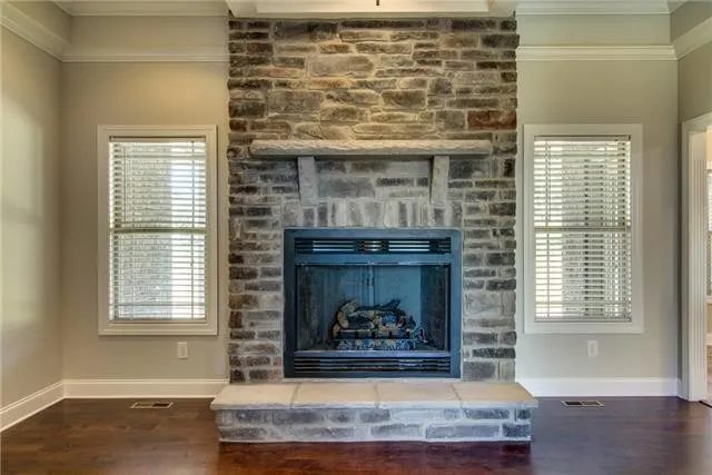 a living room with fireplace and a fireplace