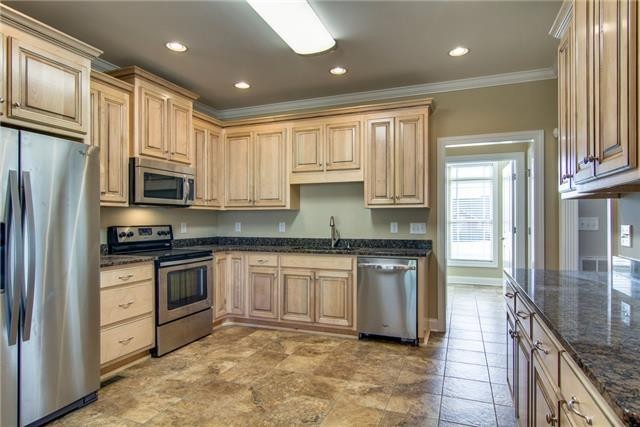 427 Favre Circle Winchester, TN 37398 - Photo 9 of 19 a kitchen with stainless steel appliances granite countertop a refrigerator stove and sink