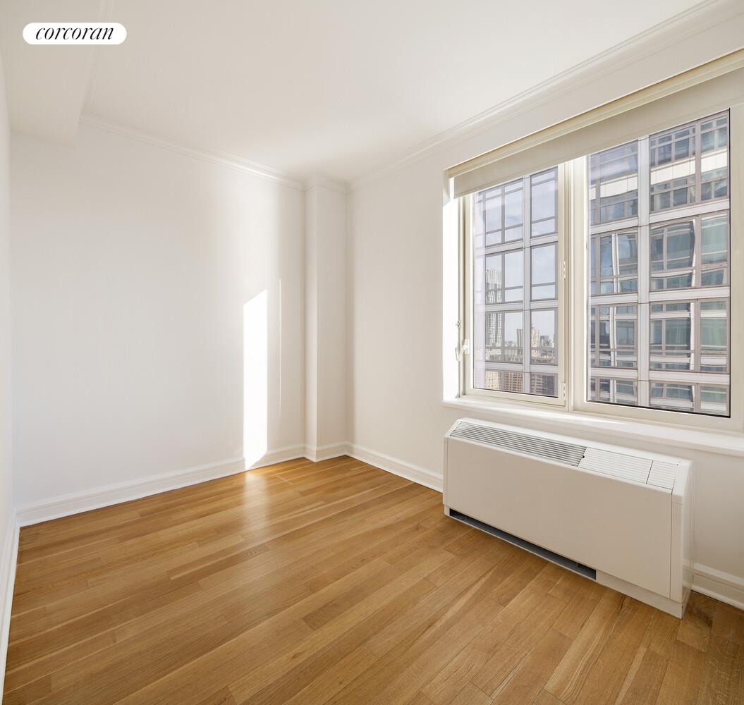 80 Riverside Boulevard, Unit 36B Manhattan, NY 10069 - Photo 17 of 25 a view of an empty room with wooden floor and a window