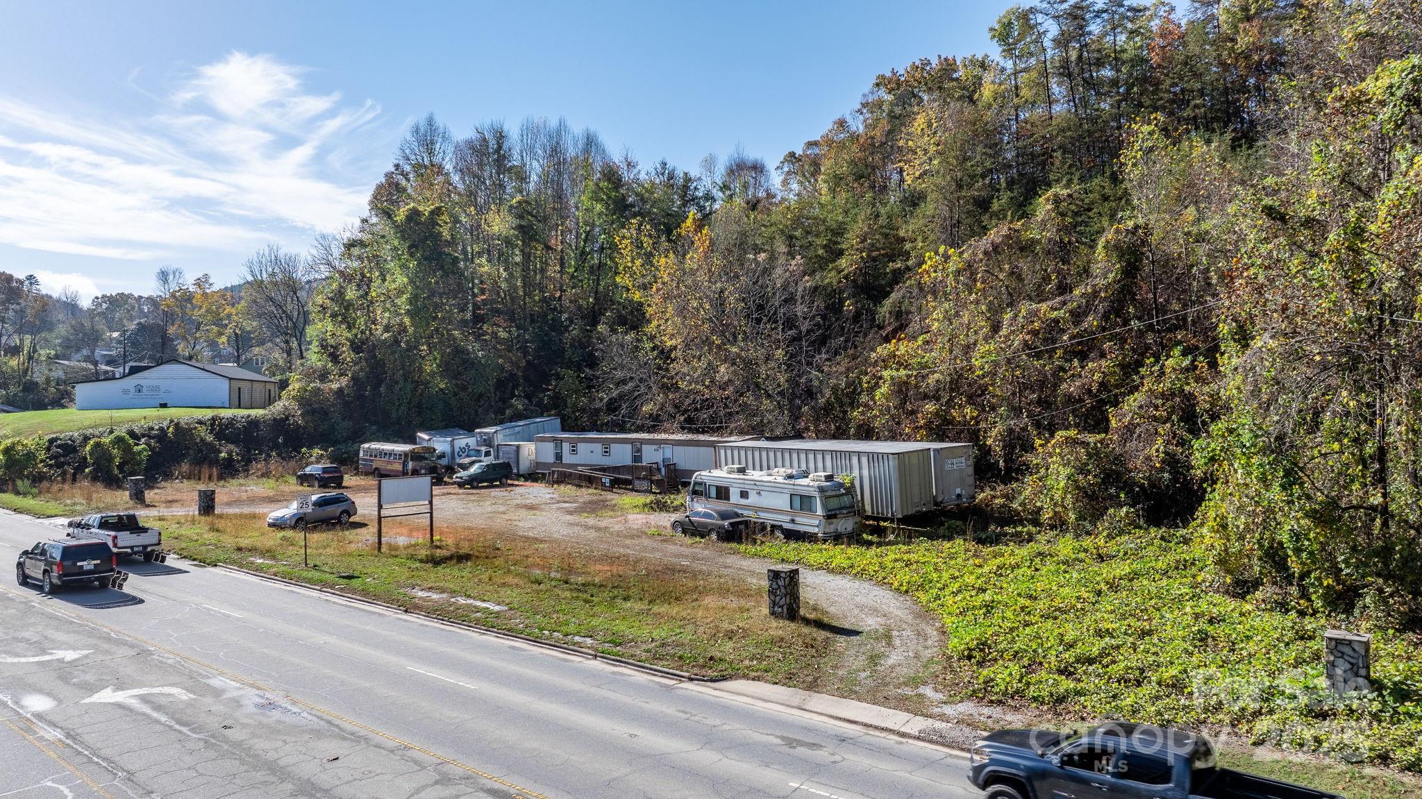 1965 North Main Street Marion, NC 28752 - Photo 3 of 23 a view of a lake with a bench and trees
