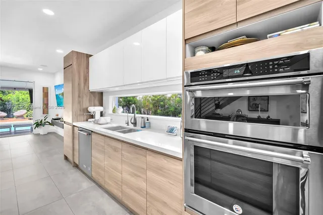 a kitchen with a sink and a white cabinets