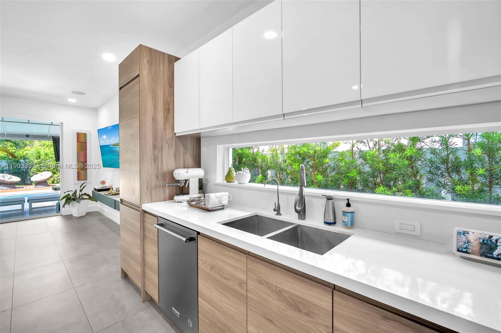 3167 Southwest 25th Street, Unit 1 Miami, FL 33133 - Photo 13 of 42 a kitchen with a sink and a white cabinets