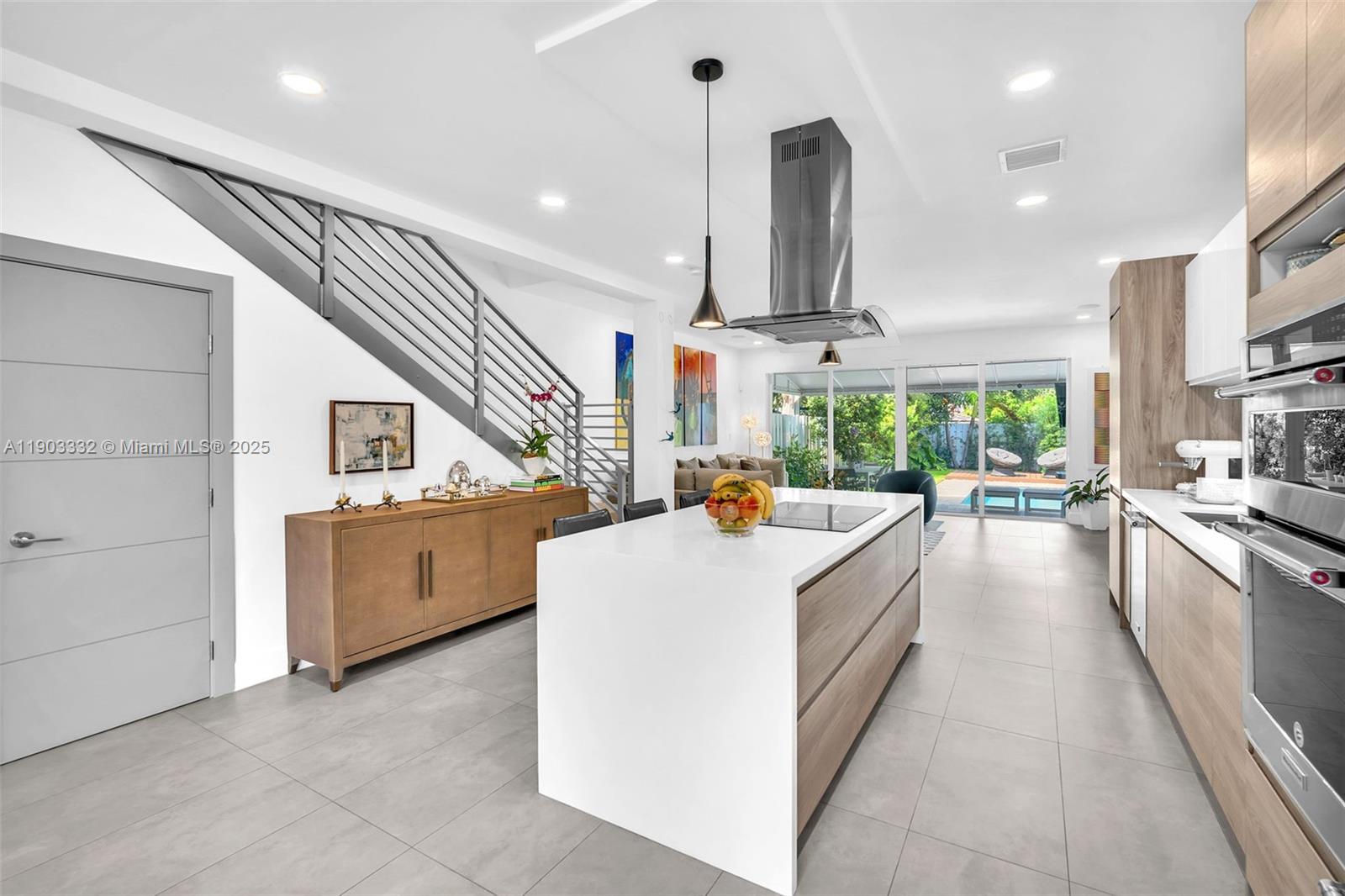 3167 Southwest 25th Street, Unit 1 Miami, FL 33133 - Photo 14 of 42 a large white kitchen with lots of counter space