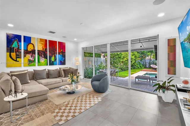 a living room with furniture and kitchen view