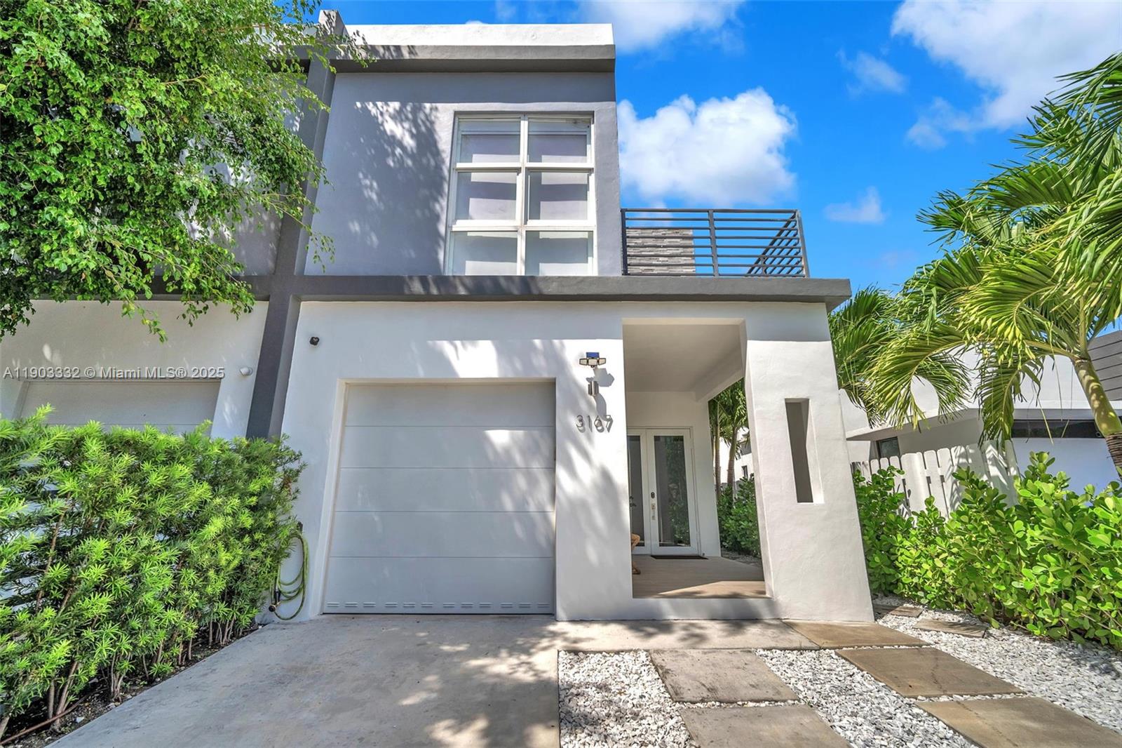 3167 Southwest 25th Street, Unit 1 Miami, FL 33133 - Photo 2 of 42 a front view of a house with a yard