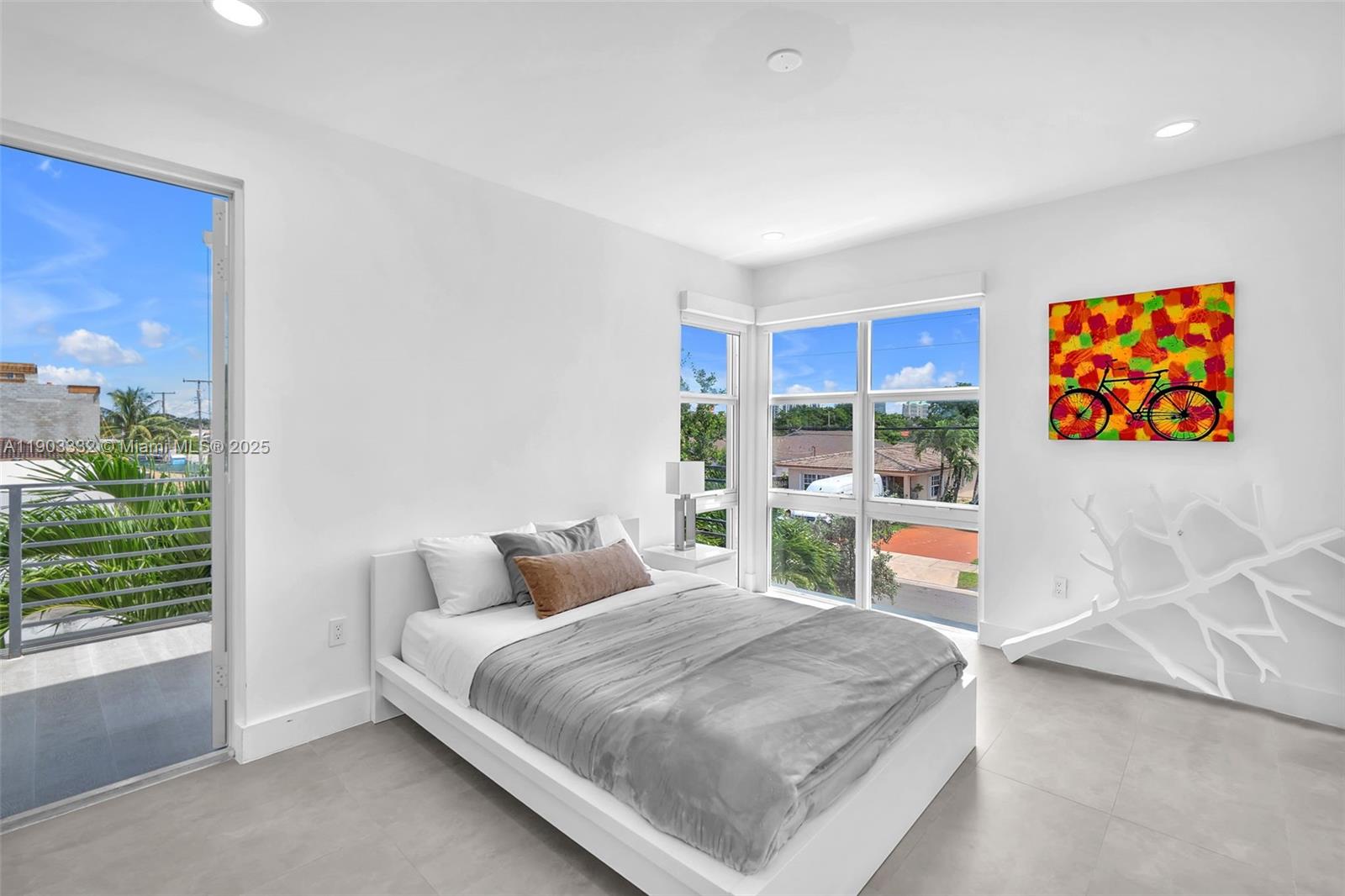 3167 Southwest 25th Street, Unit 1 Miami, FL 33133 - Photo 25 of 42 a bedroom with a large bed and a window