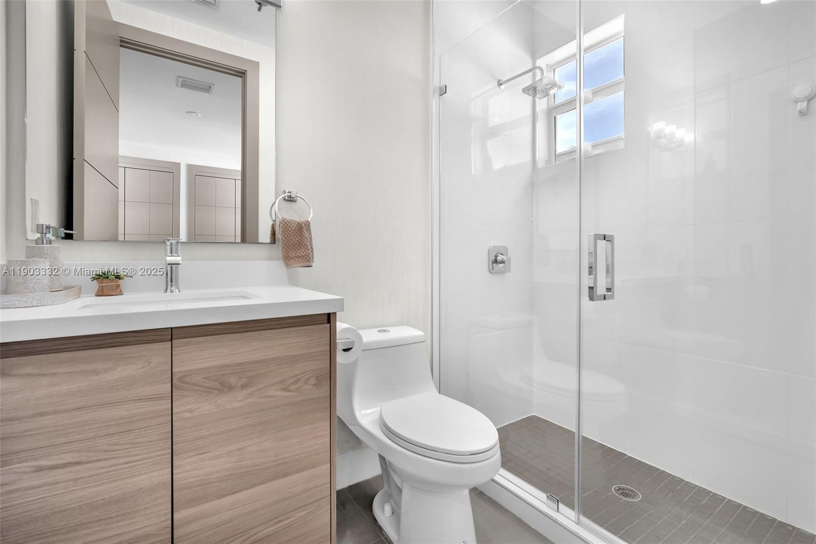 3167 Southwest 25th Street, Unit 1 Miami, FL 33133 - Photo 26 of 42 a bathroom with a sink a toilet and shower