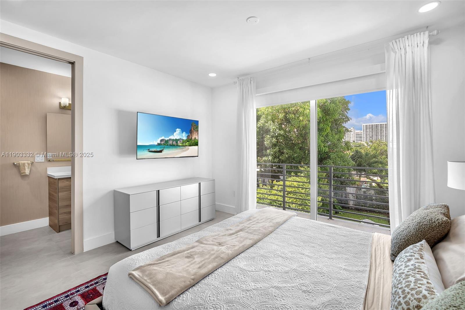 3167 Southwest 25th Street, Unit 1 Miami, FL 33133 - Photo 31 of 42 a bedroom with a large bed and a large window