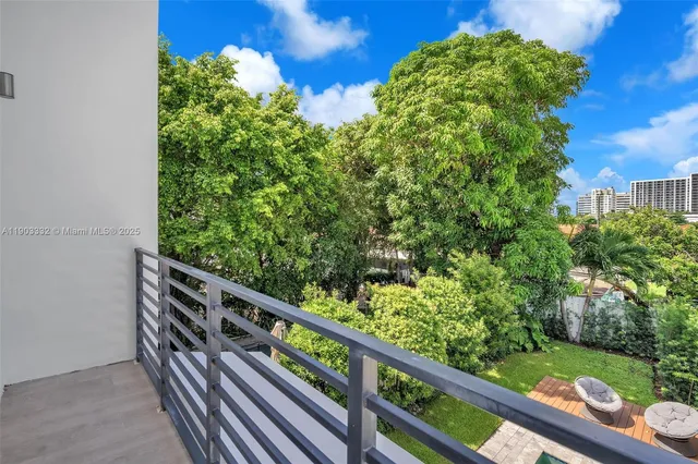 a view of a patio with table and chairs potted plants with wooden floor and fence