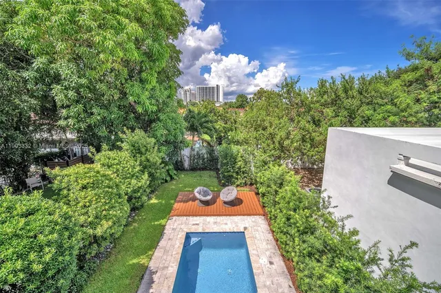 a view of a swimming pool with an outdoor space and seating area