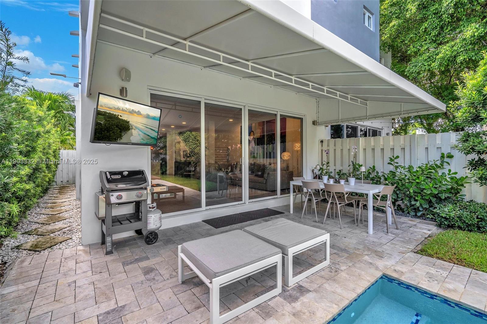 3167 Southwest 25th Street, Unit 1 Miami, FL 33133 - Photo 38 of 42 a view of a patio with table and chairs potted plants with wooden floor and fence