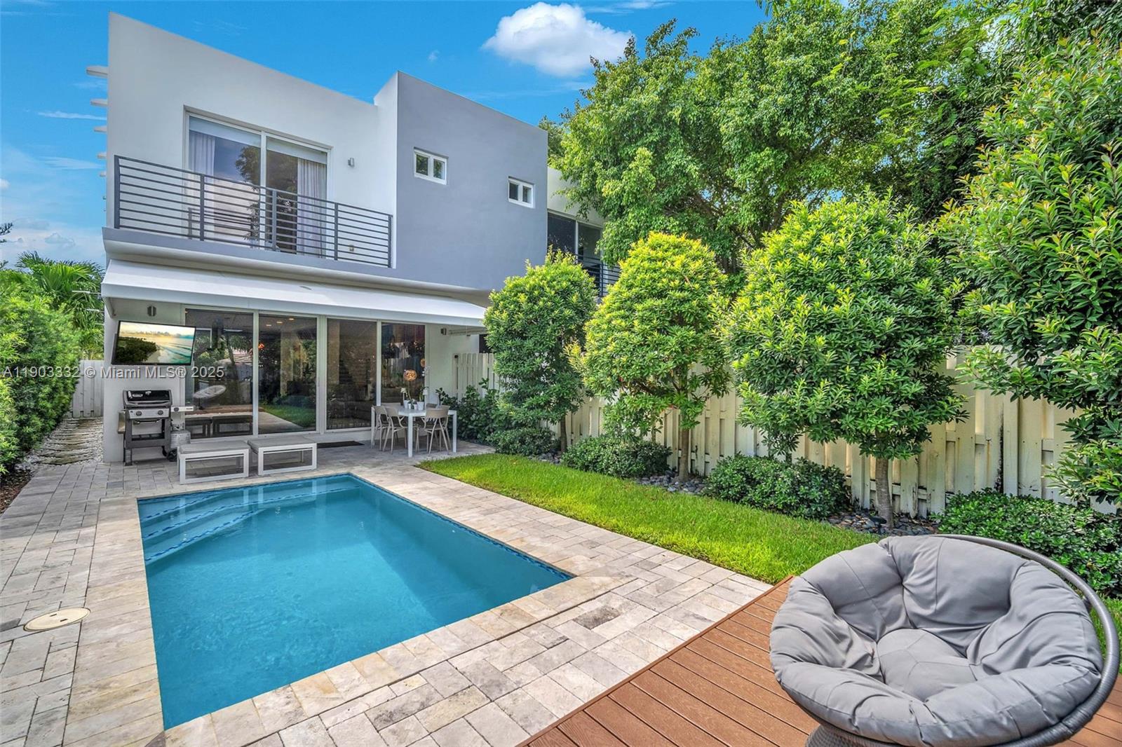 3167 Southwest 25th Street, Unit 1 Miami, FL 33133 - Photo 41 of 42 a view of a patio with table and chairs potted plants and large tree