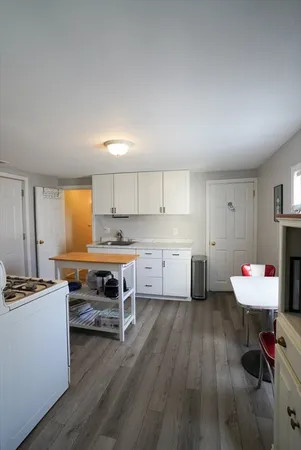 a kitchen with a stove and white cabinets