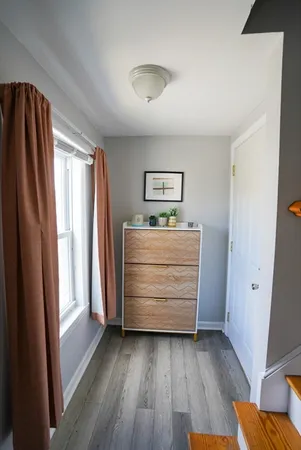 a room with a dresser and a window