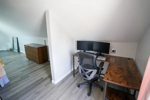 a view of workspace with wooden floor and chair