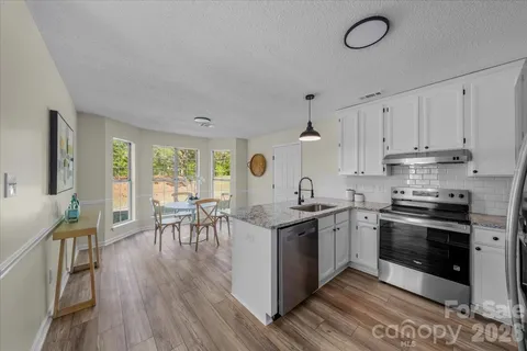 a kitchen with stainless steel appliances and a stove top oven