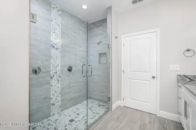 a bathroom with a shower and a sink